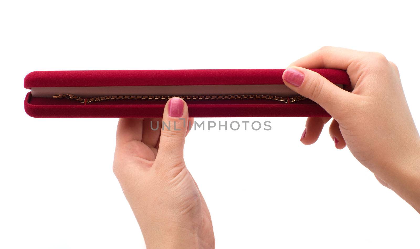 Red box with a gold bracelet in female hands, a close up on a white background.
