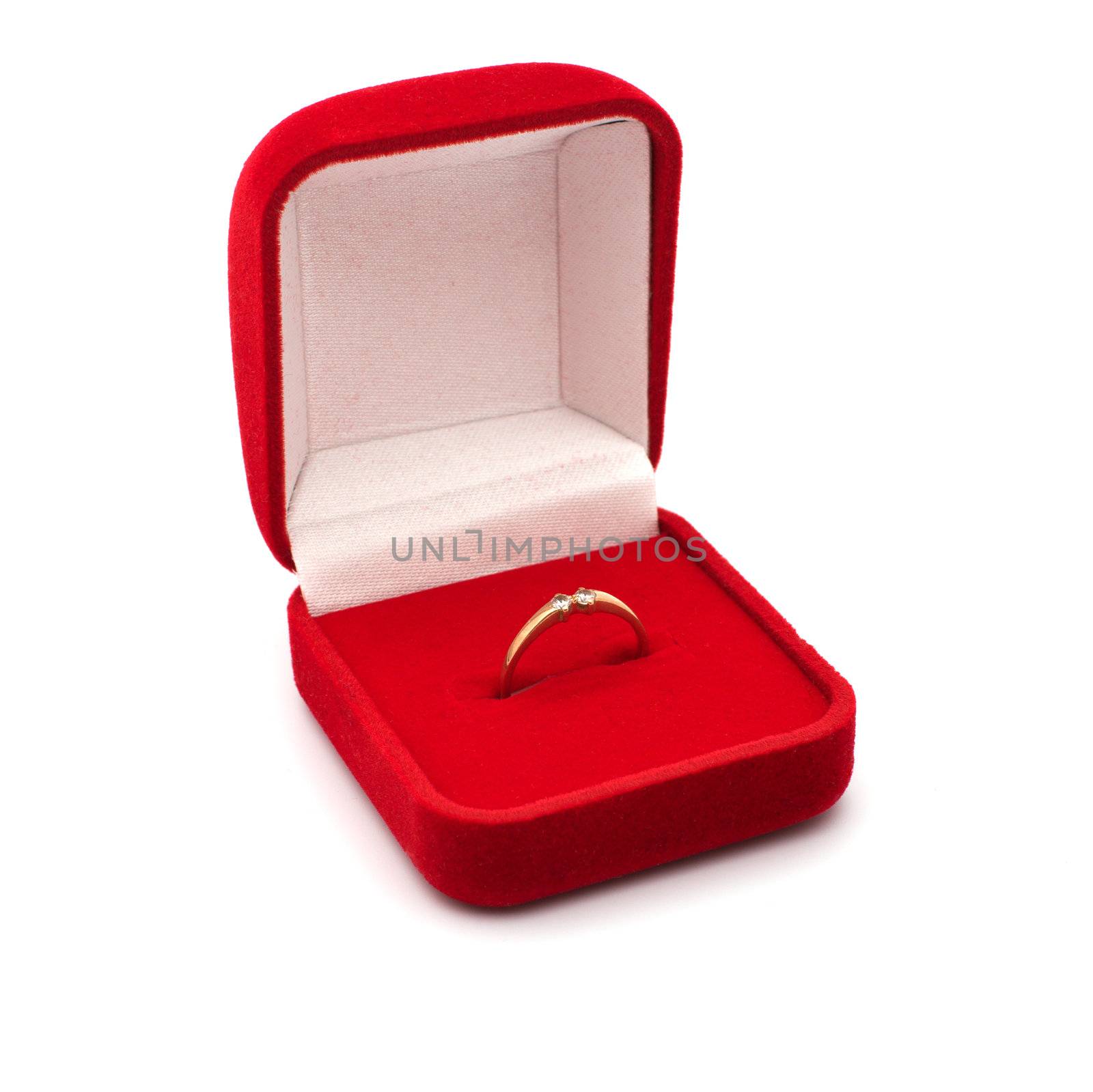 Red box for jeweller ornaments and a gold ring with brilliants.