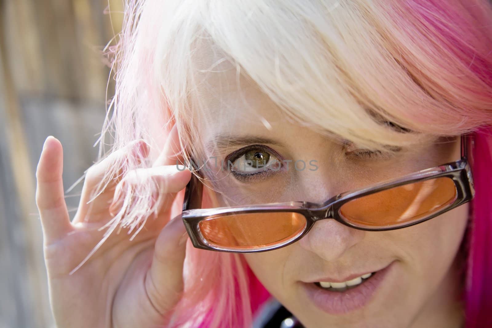 Pretty Young Woman with Brightly Colored Hair Looking Over the Top of her Sunglasses
