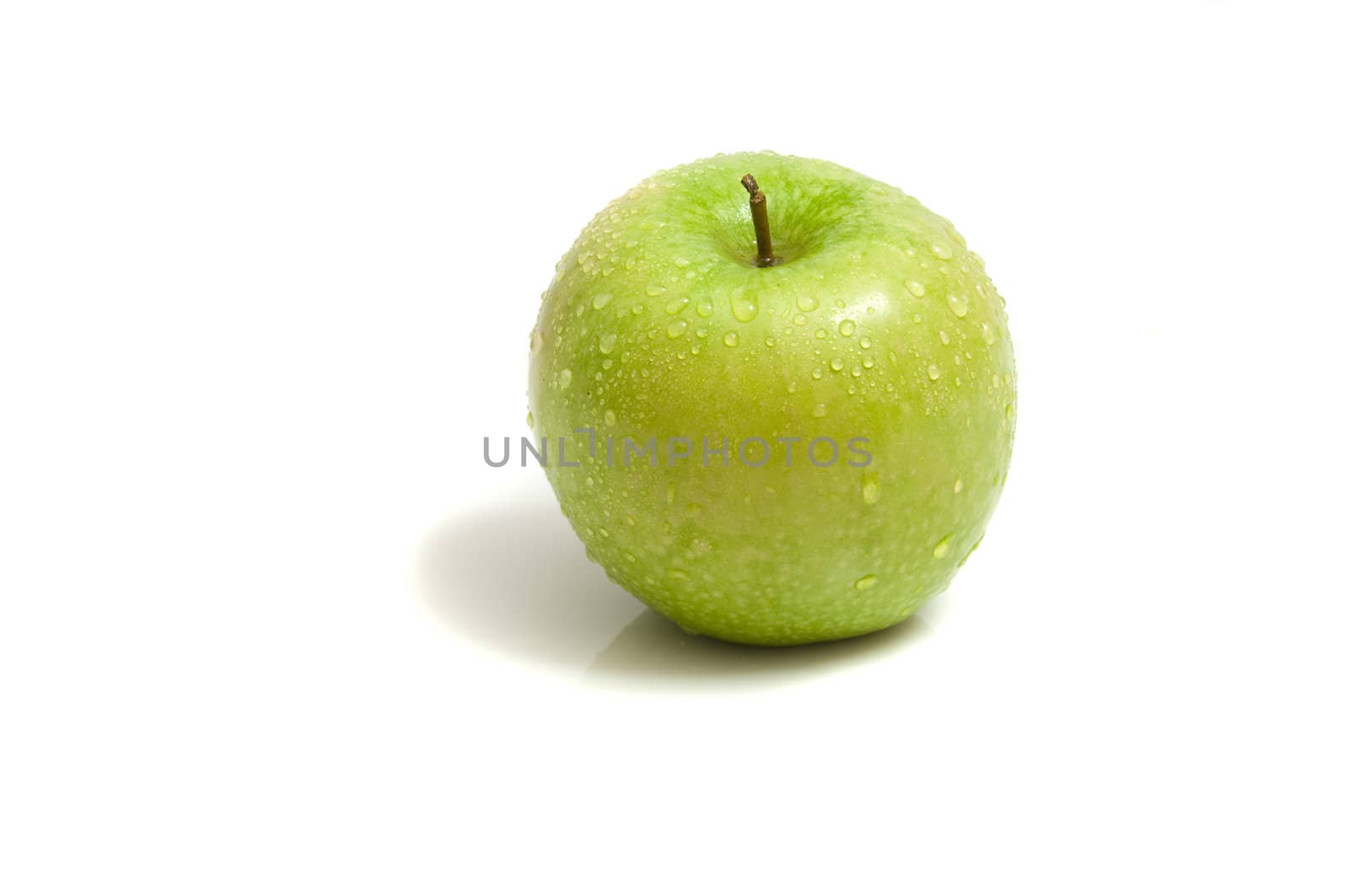 close up on a fresh, organic green apple, isolated on white, copy space
