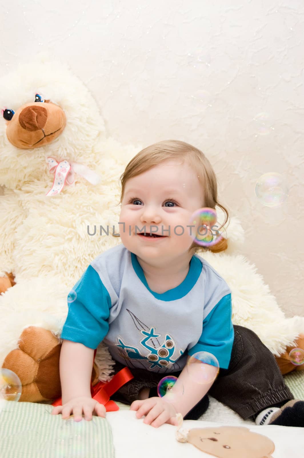 Cute baby boy having fun with bubbles