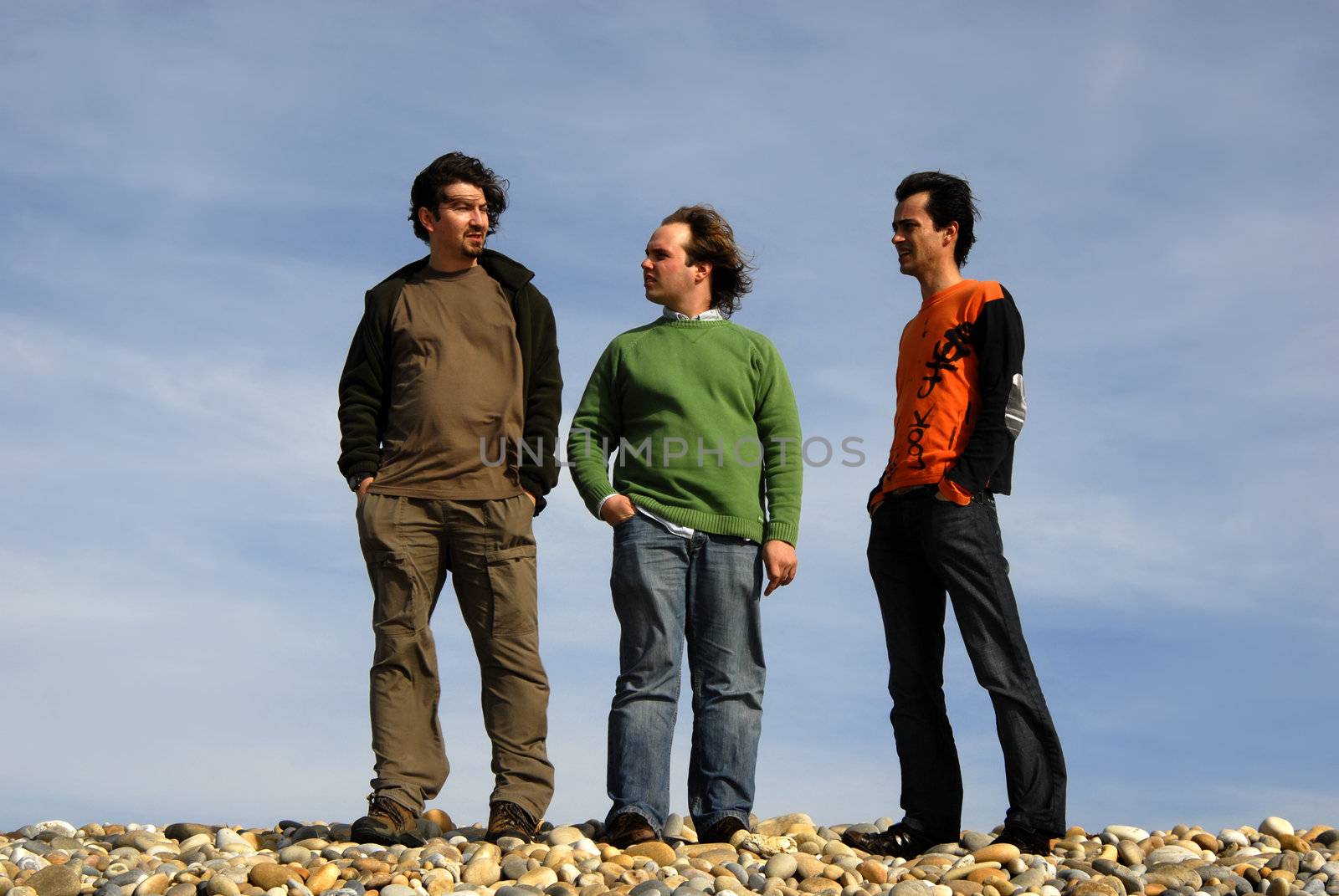 three casual young men at the beach