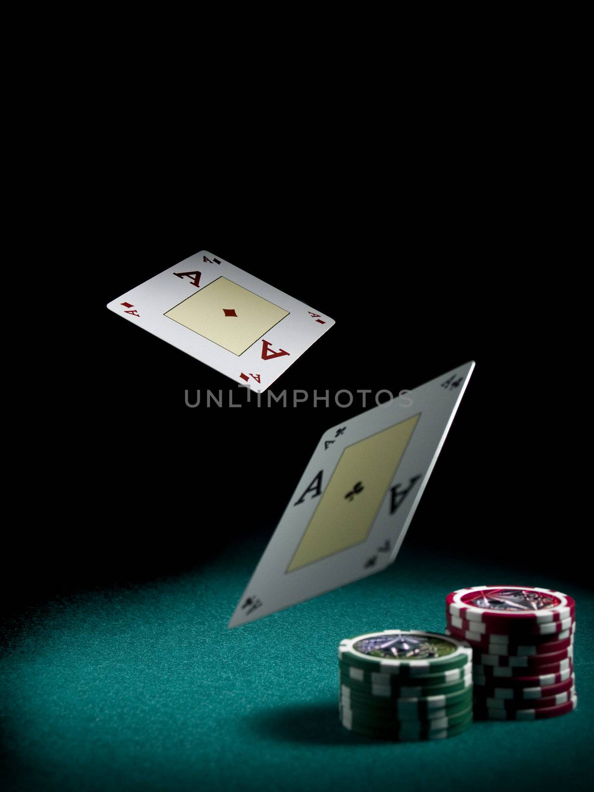 Two aces flying over a green felt with three piles of different colors chips.