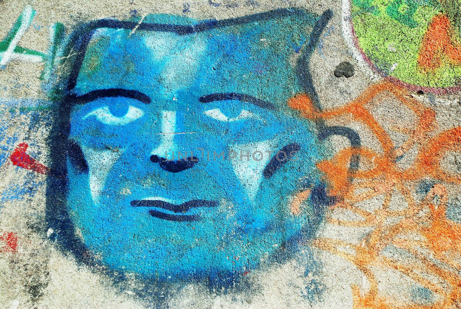 A photograph of a spray painted graffiti face