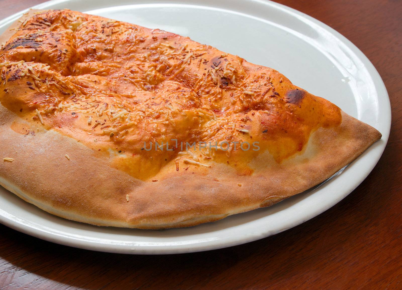 Delicious hot Calzone pizza  On a plat. Close-up