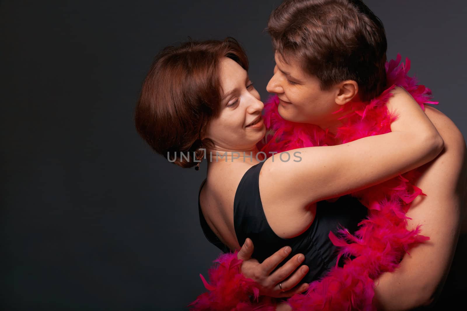 Close-up of a young couple in pink feathers