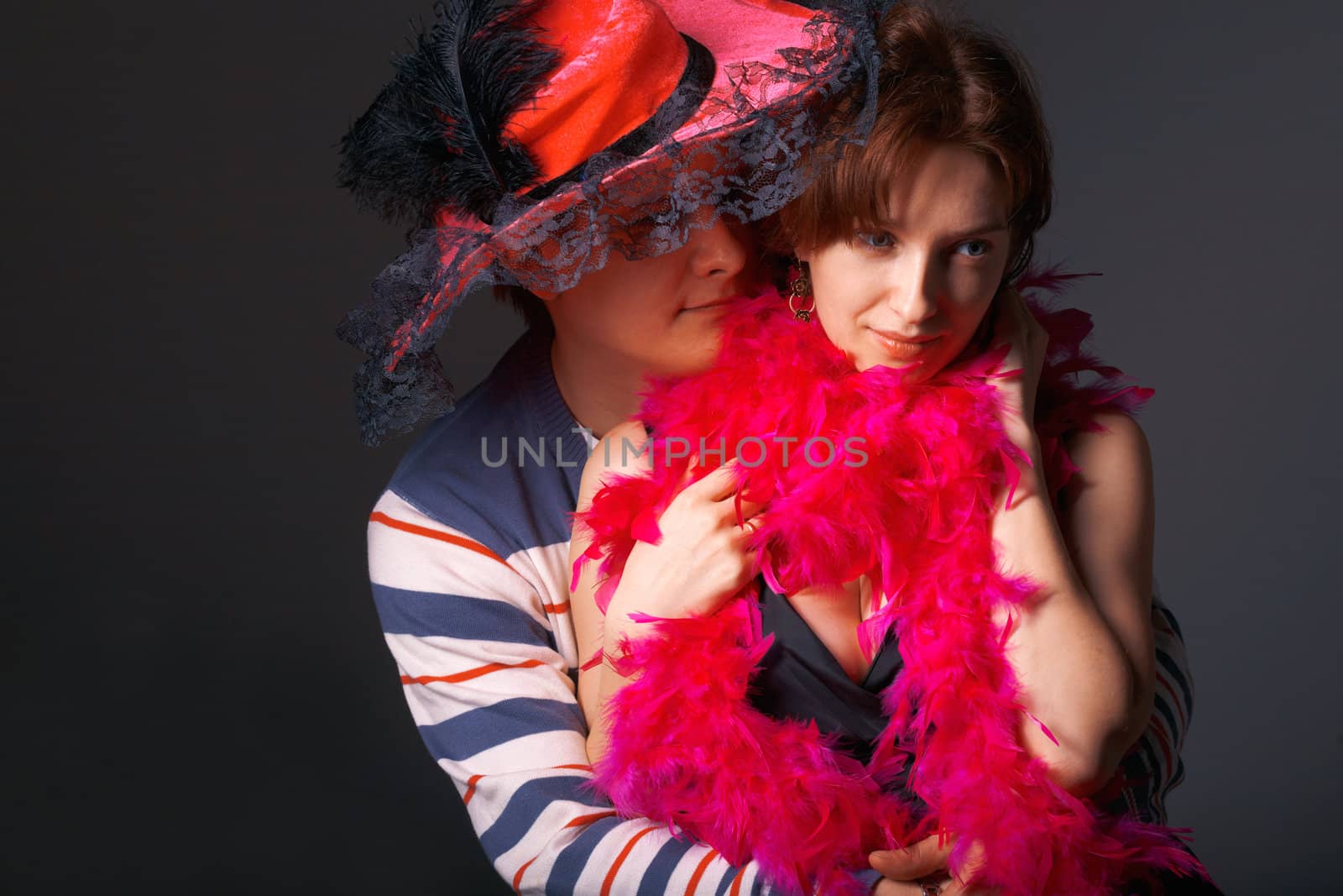 Close-up of a young couple in pink feathers