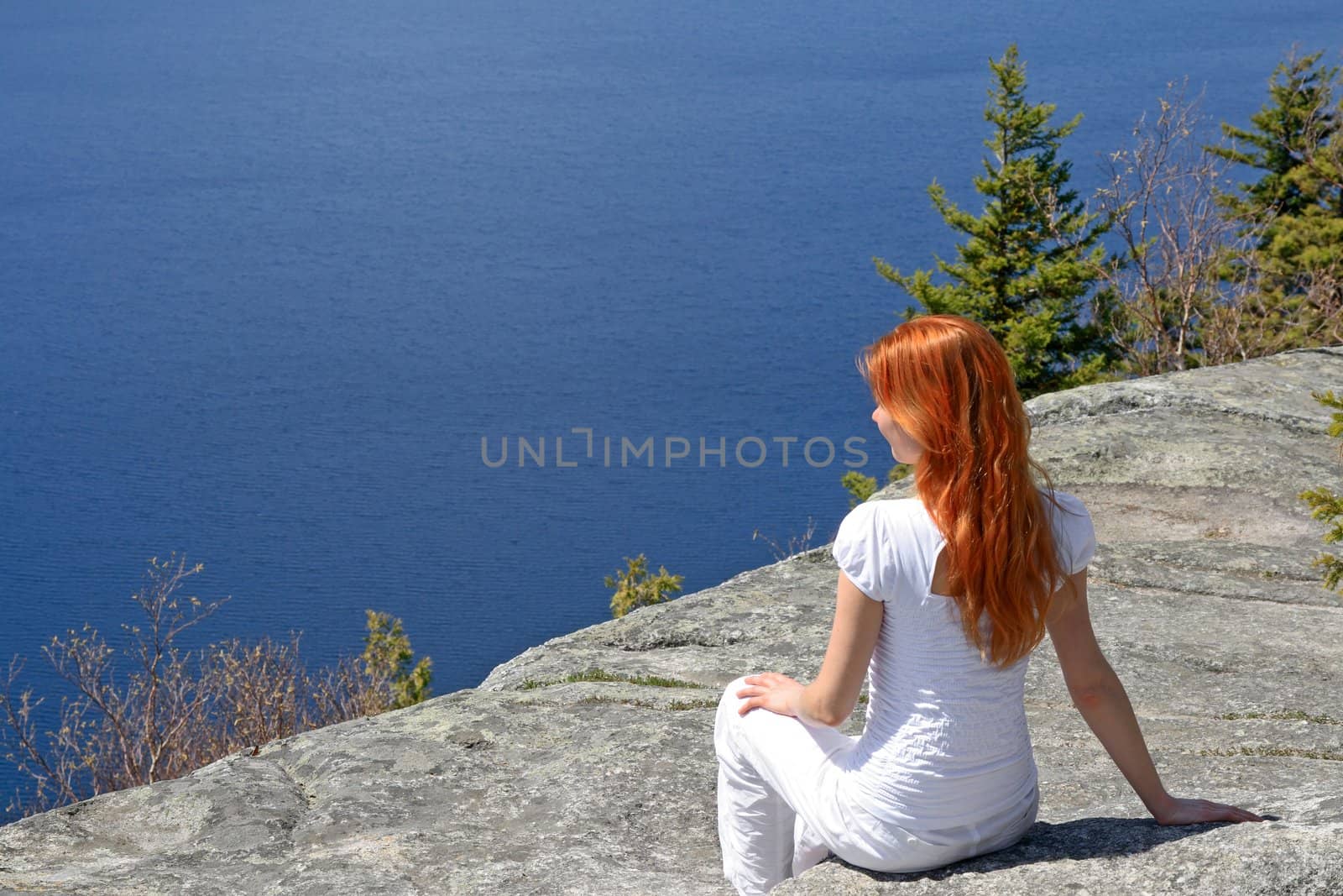 Girl sitting on a rock, enjoying the view by anikasalsera