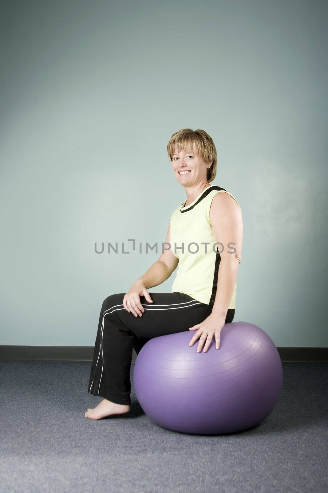 Portrait of a Pretty Woman Sitting on an Exercise Ball