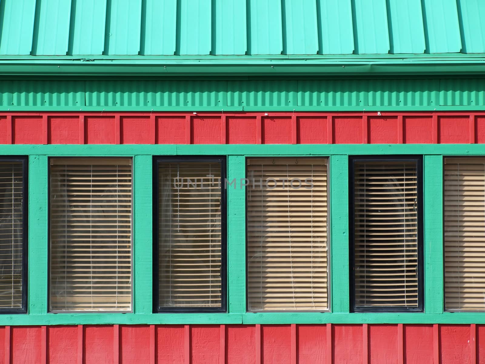 A red building with green trimmed windows, great bold box shapes for text.