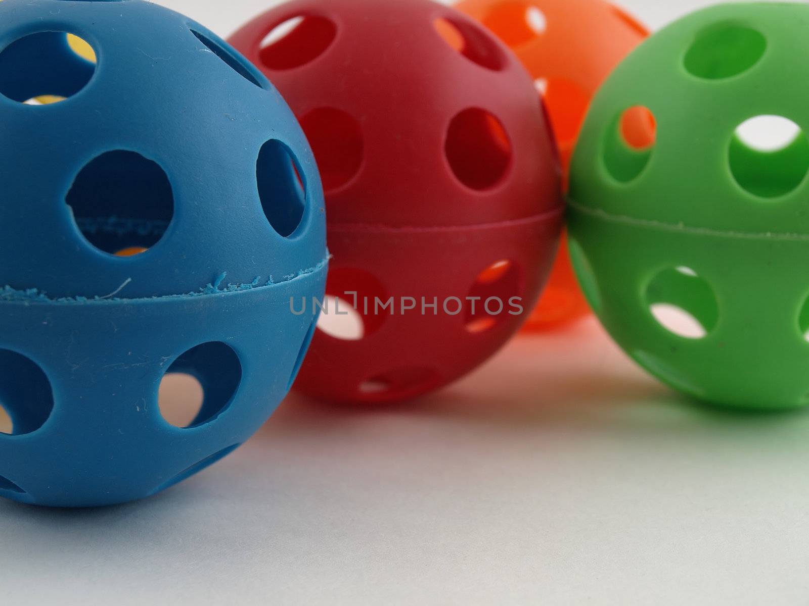 Colorful plastic balls with holes isolated on a white background.