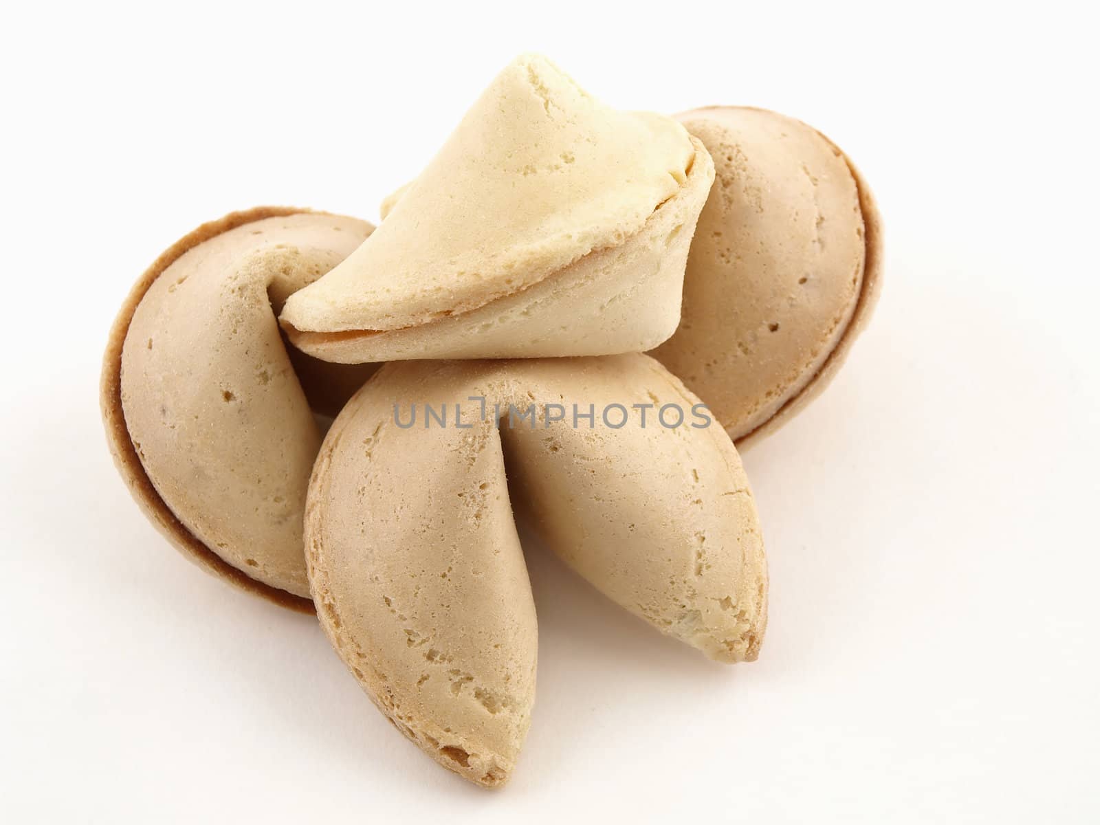 A cluster of four fortune cookies isolated on a white background