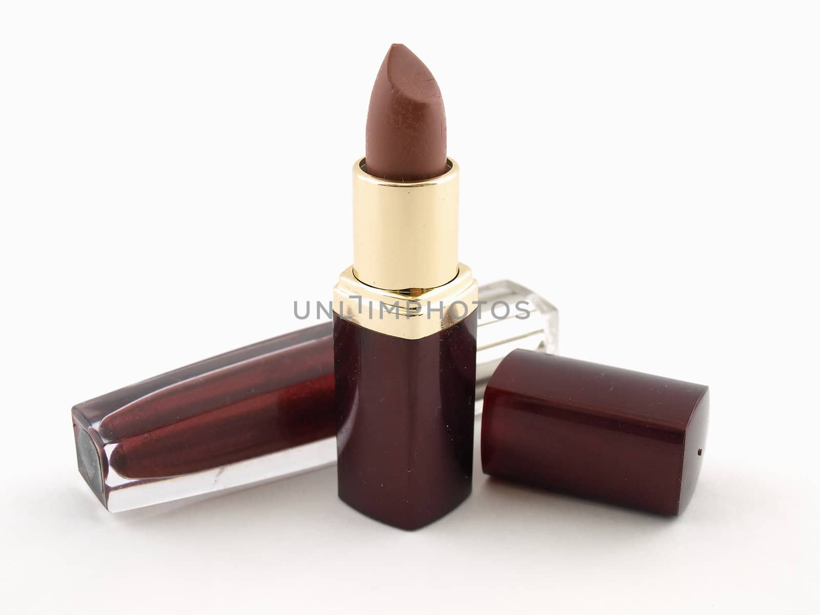 Two lipstick compacts, one with the lid off isolated on a white background