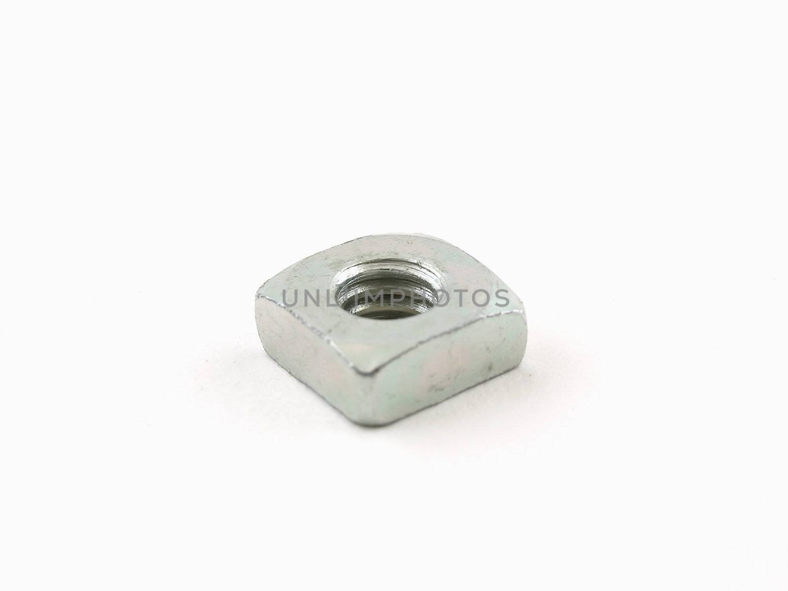 A single steel nut isolated on a white background.