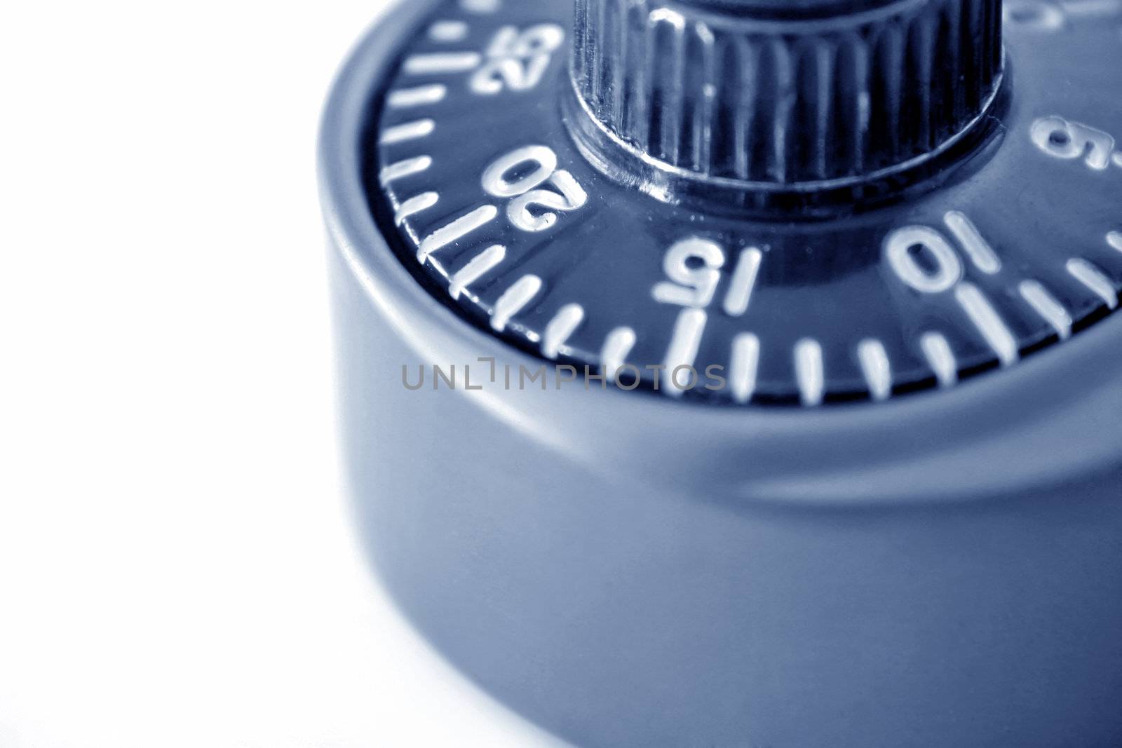 close up of a padlock dial with focus on the number 20 and done in a cool blue tone.
