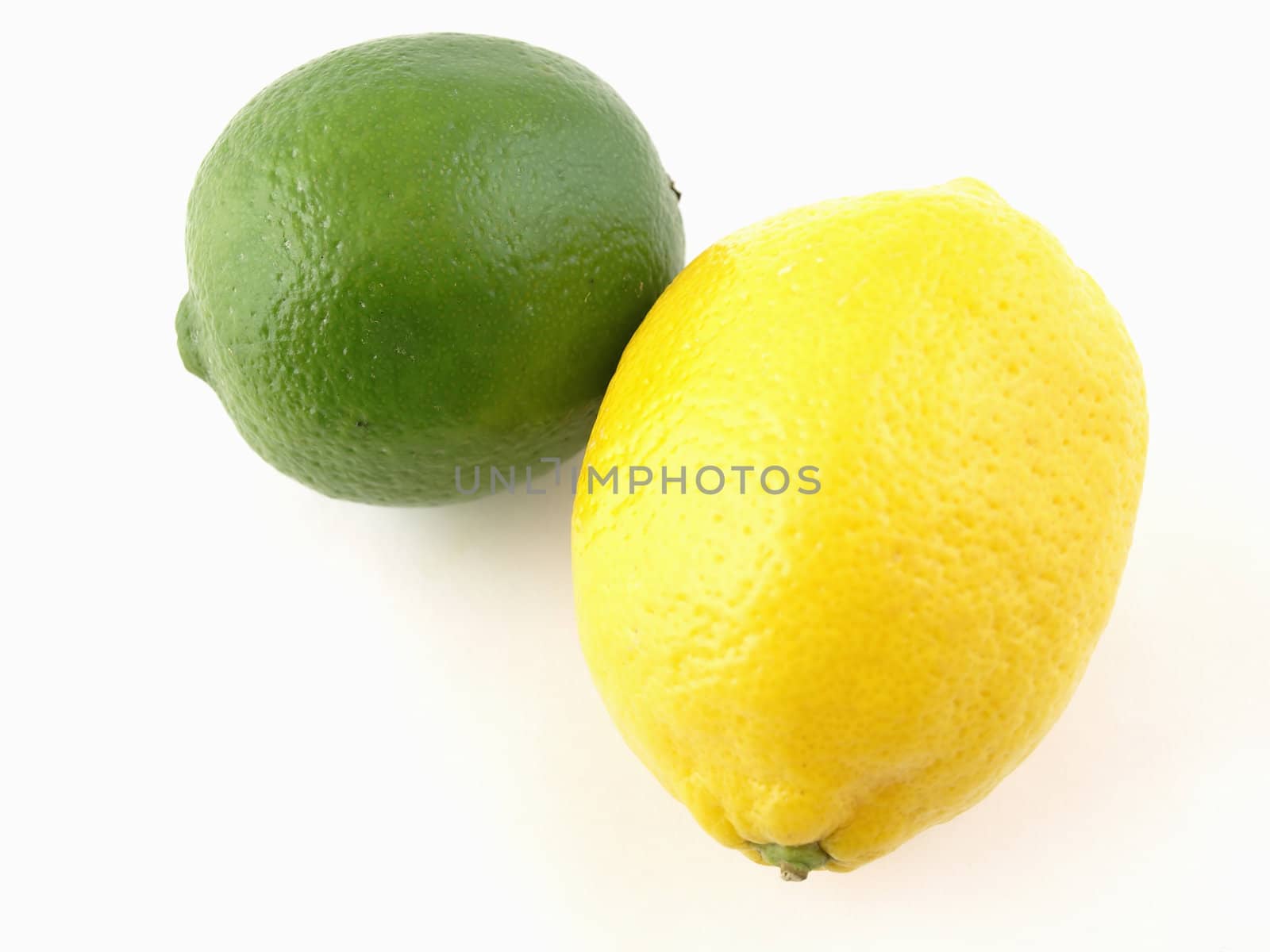 A green lime and a yellow lemon isolated on a white background