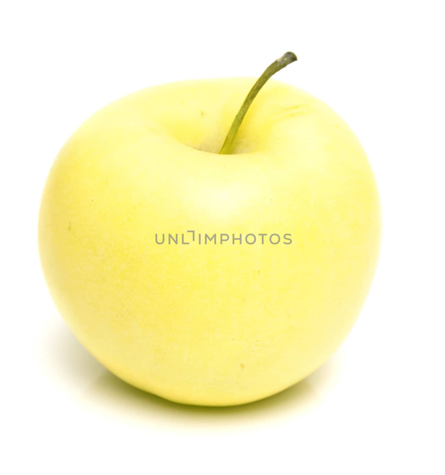The ripe juicy yellow apple . Isolation on white, shallow DOF.