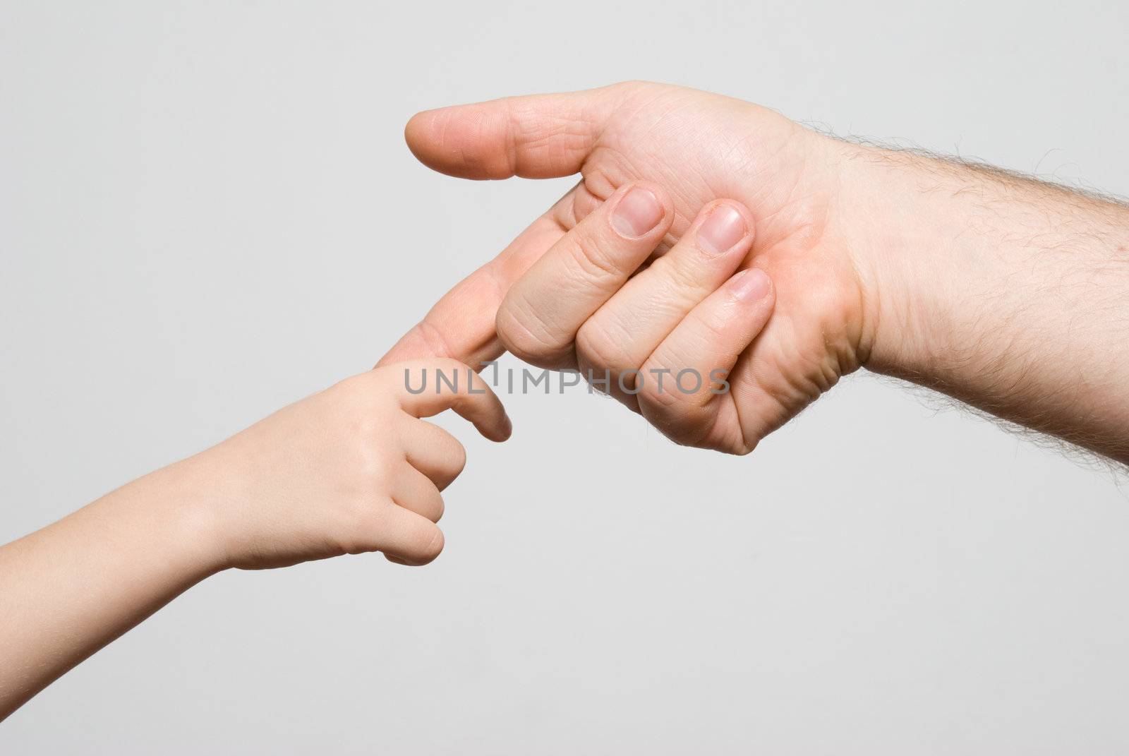 Children's hand in a man's hand