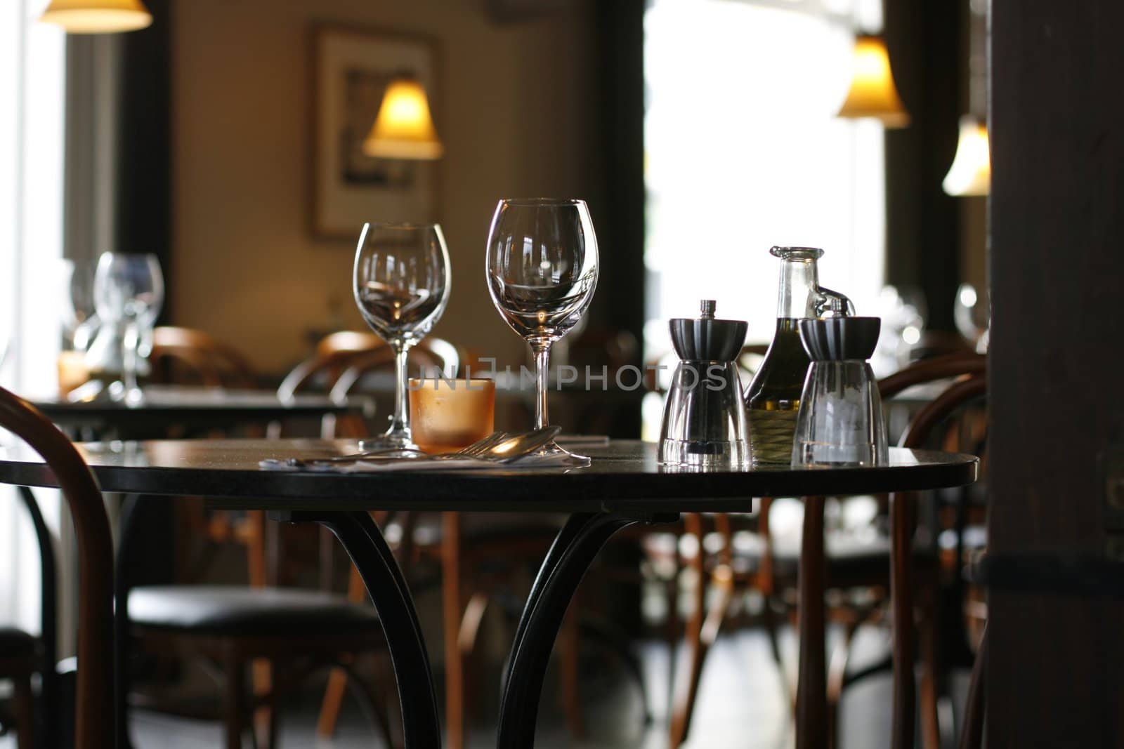 Interior of a cozy restaurant focusing on a ready table for two