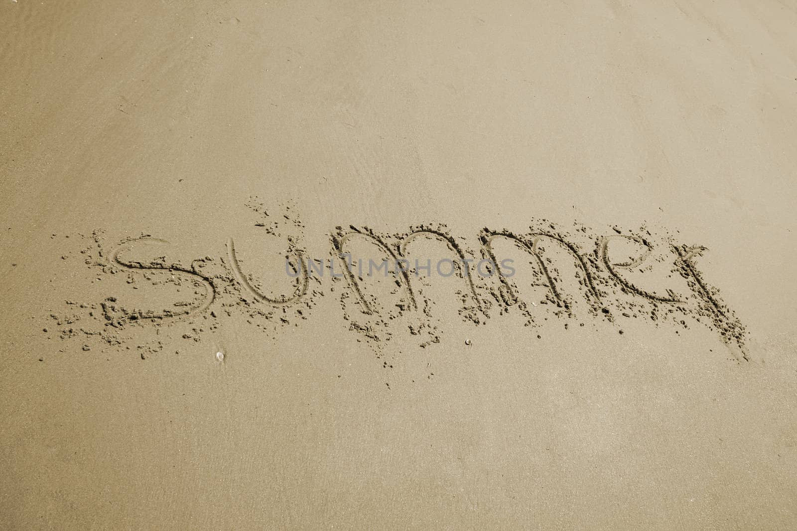 the word summer written in sand