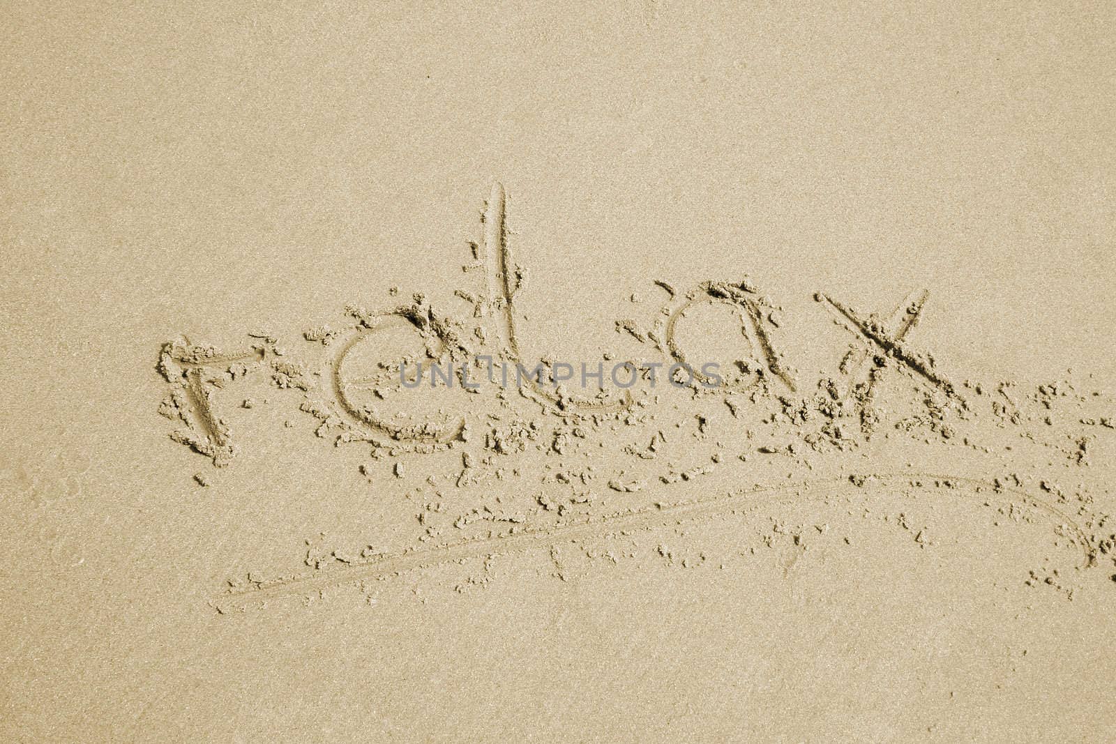 the word relax written in sand