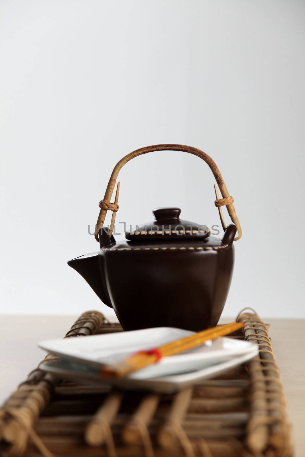 shot of the tea pot and the plate with chopsticks