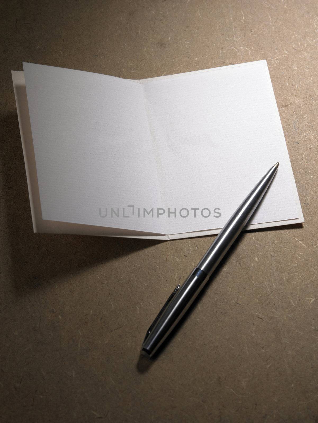 pen resting on a blank card