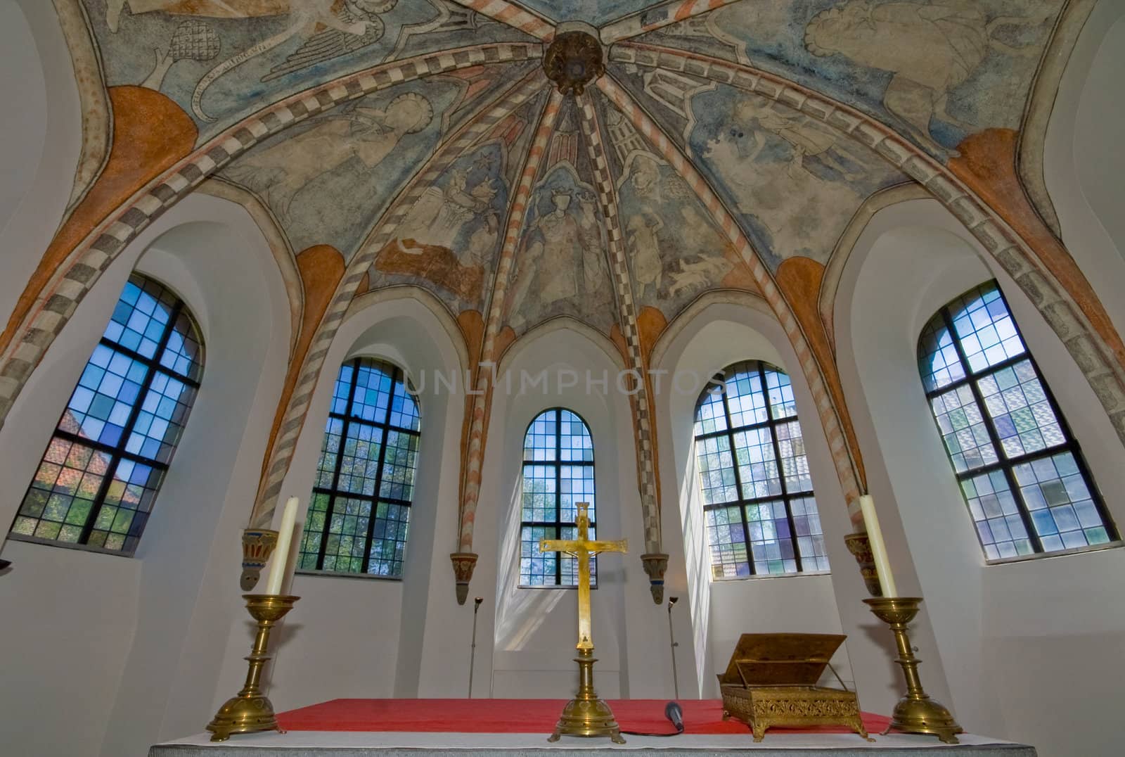 five windows of a church from inside with frescos on the ceiling
