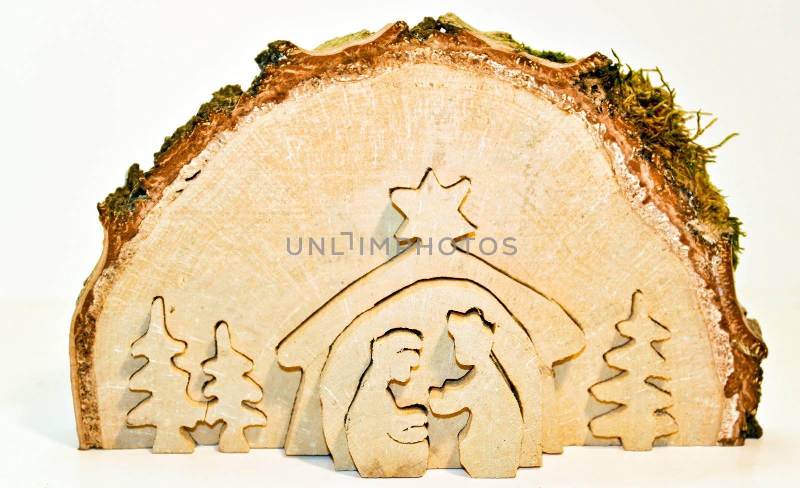 Cut out of birch tree slice showing christmas nativity: Mary, Joseph, baby Jesus