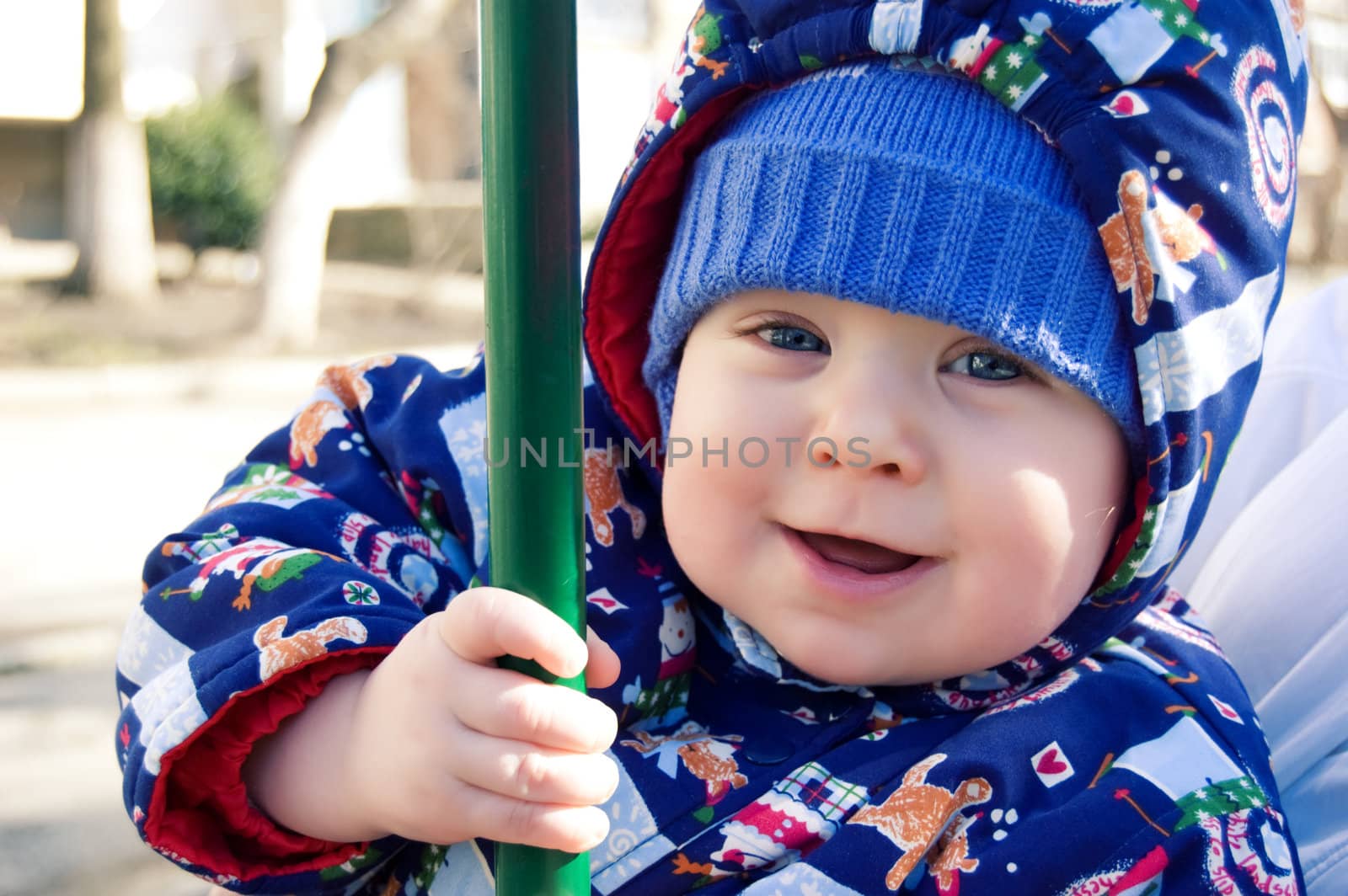 Cute baby boy in hood outdoor