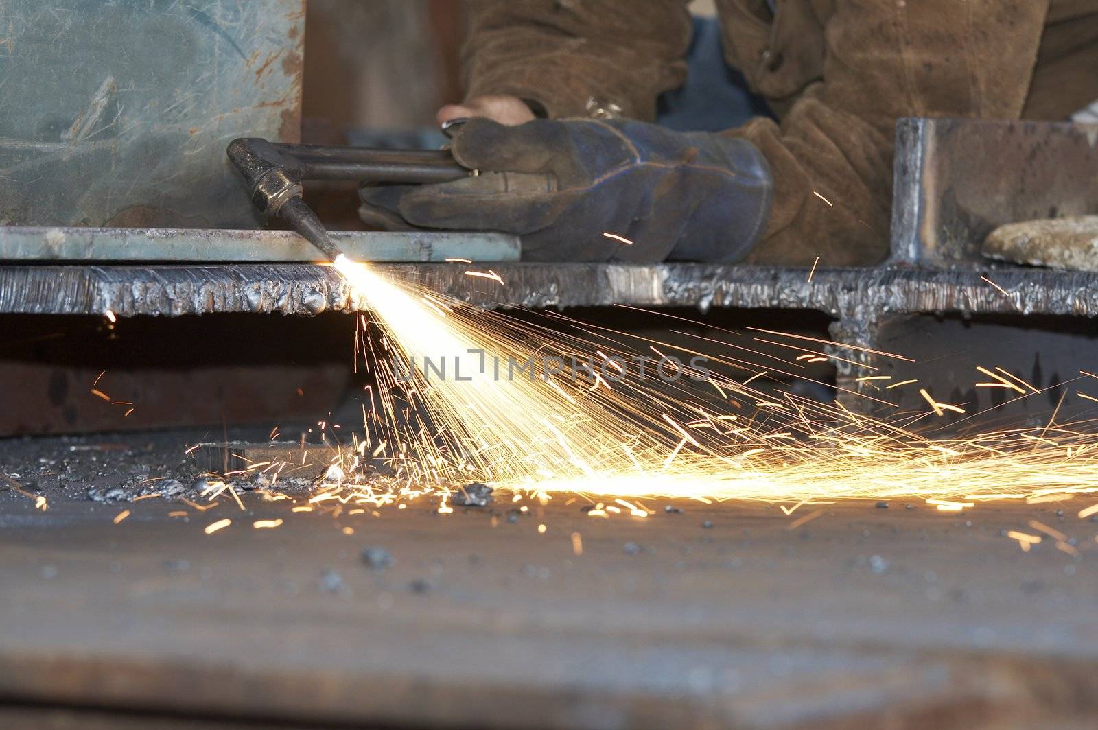 a shipyard steel worker burning steel