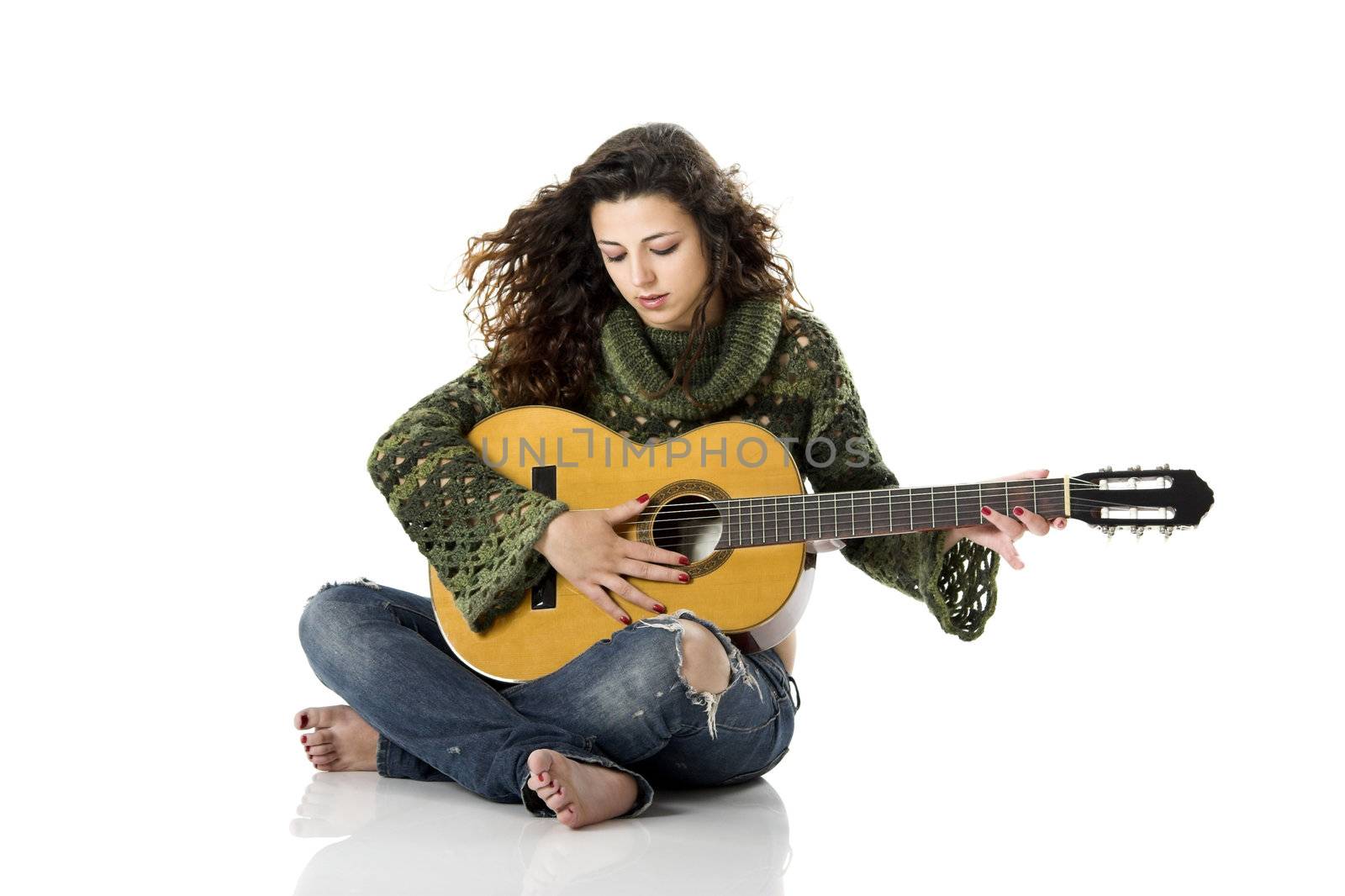 Beautiful woman isolated on white playing music with a guitar