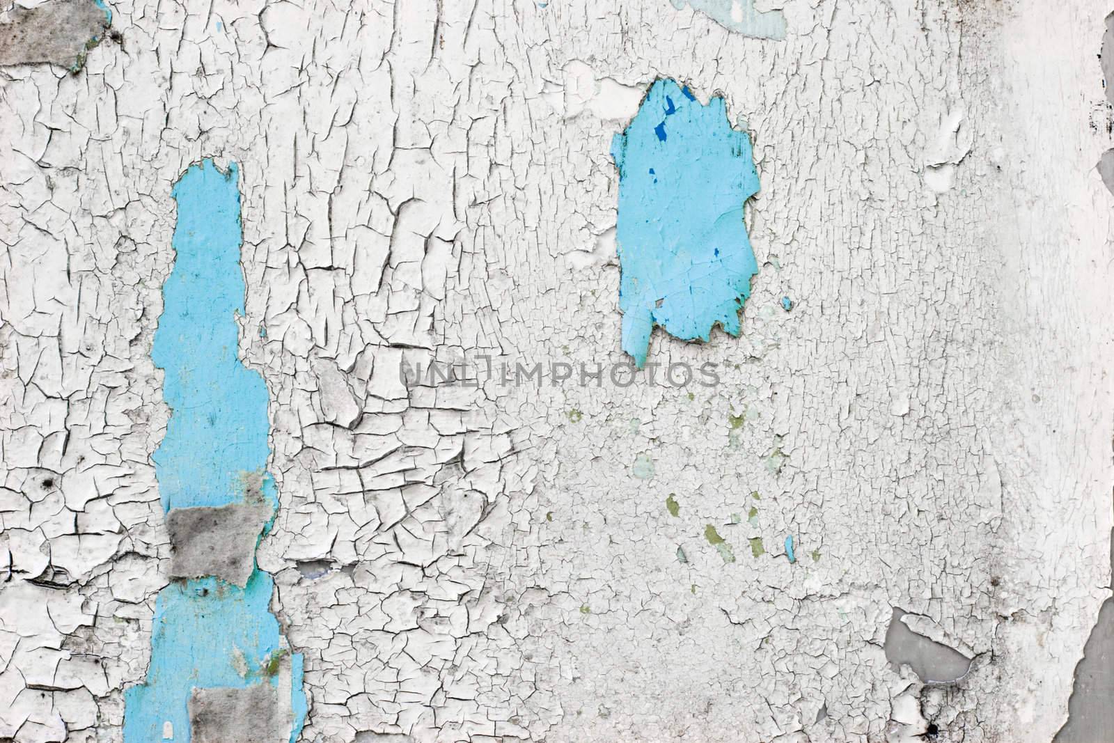 Blue and white peeling paint on the wall grunge background
