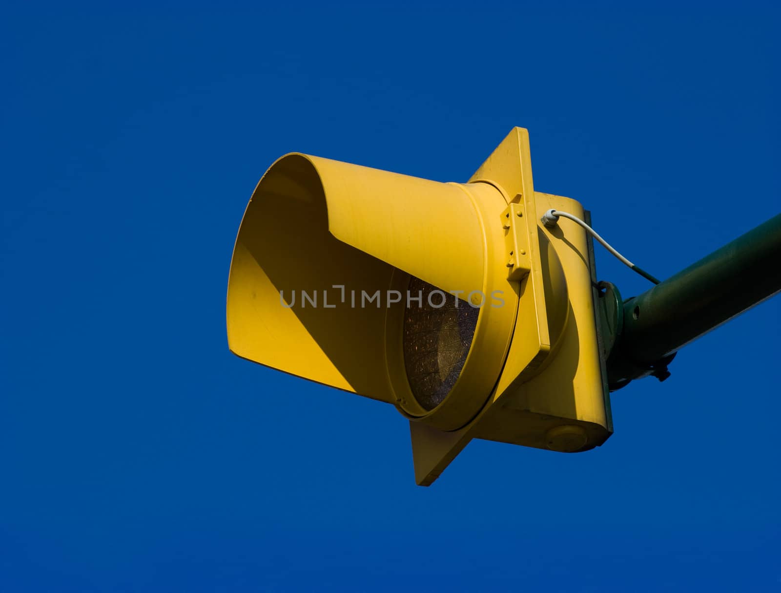 Yellow pedestrian crossing traffic light against deep blue sky. Clipping path included for easy background replace