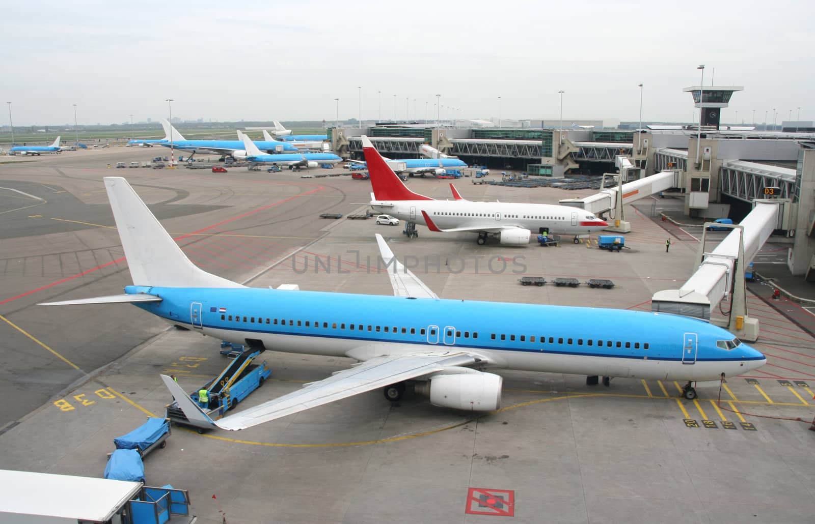 Airplanes parked at the gateways at the airfield