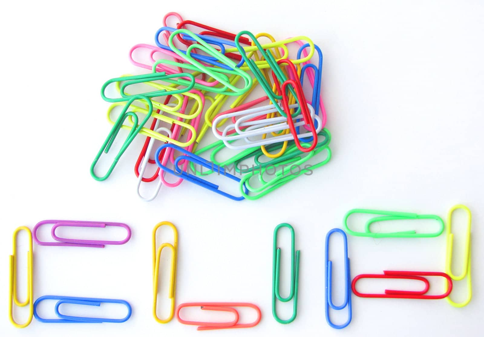 Spelling "CLIP" with paper clips on white background.
