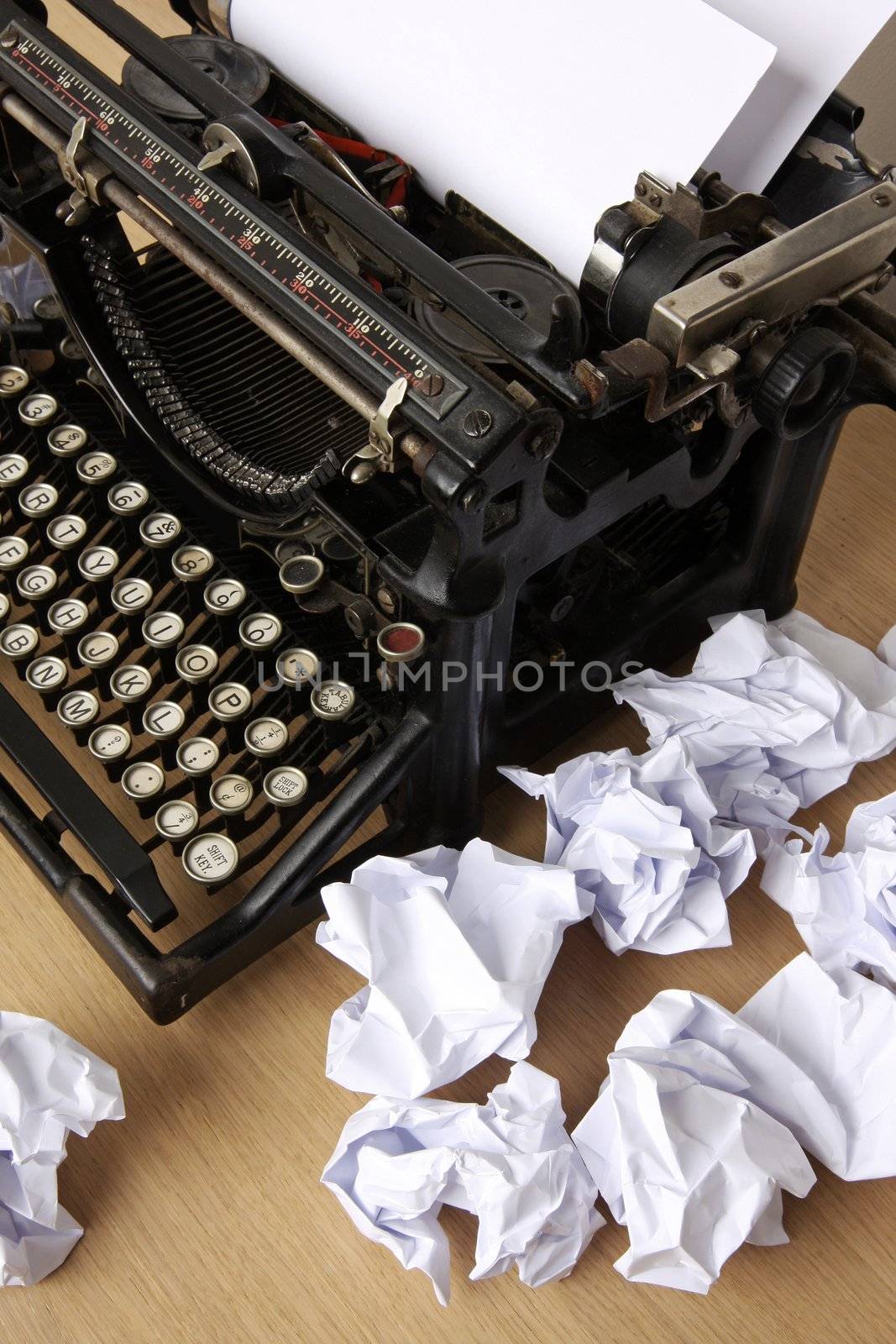 Retro typewriter with paper scattered all around - conceptual image for creative block