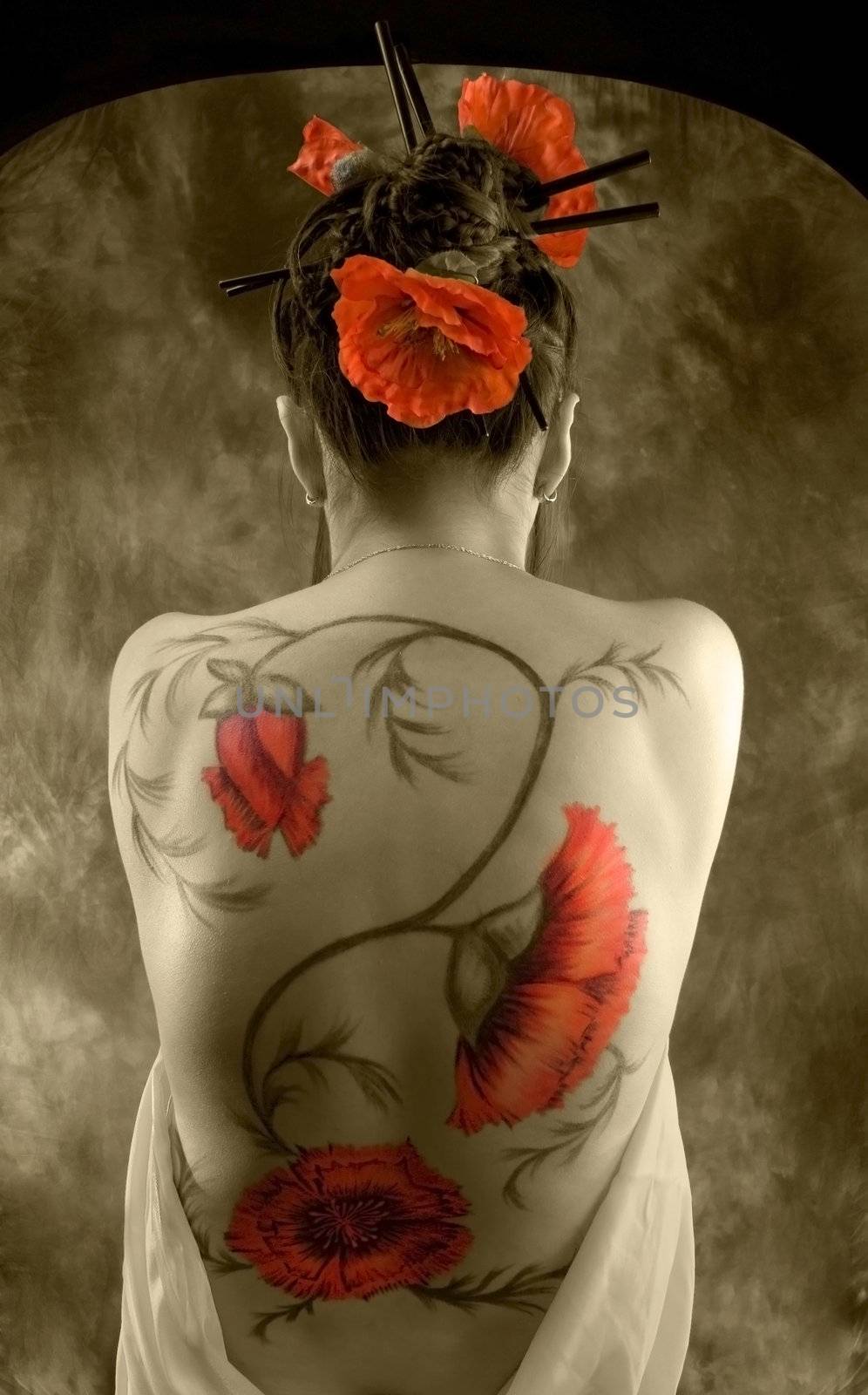 beautiful young asiatic girl with red poppies in her hear and tatto on her back