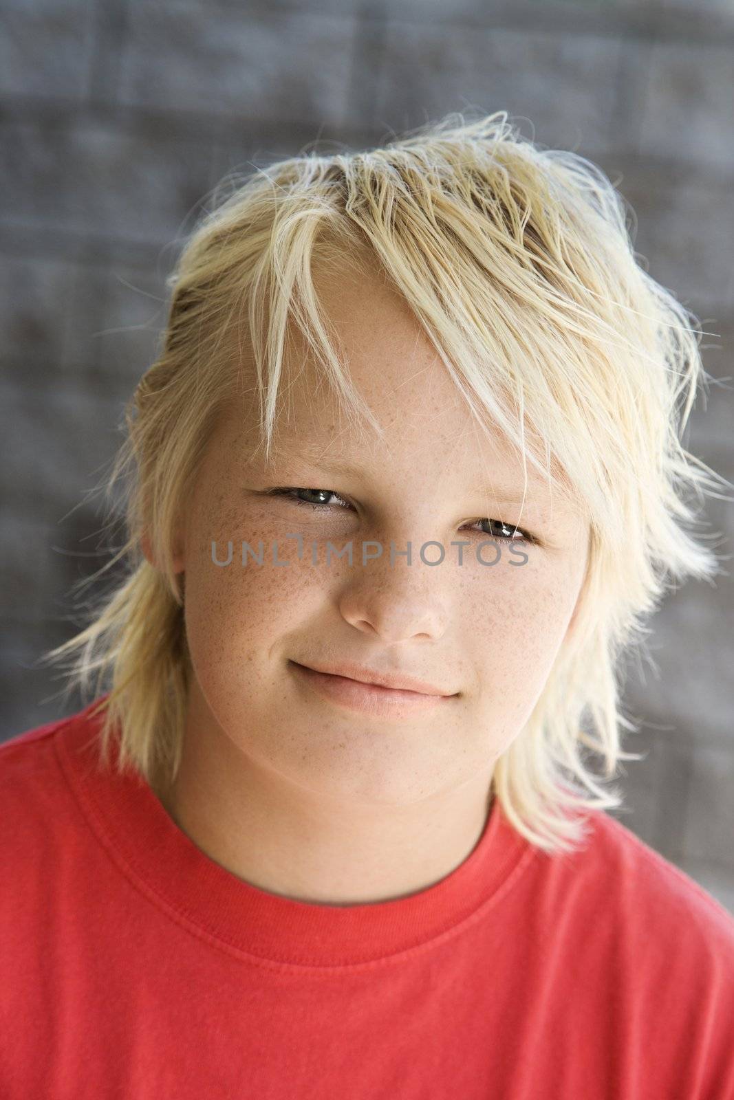 Blonde boy smiling. by iofoto