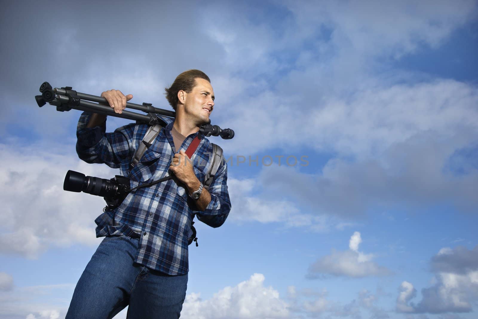 Man holding photography equipment. by iofoto