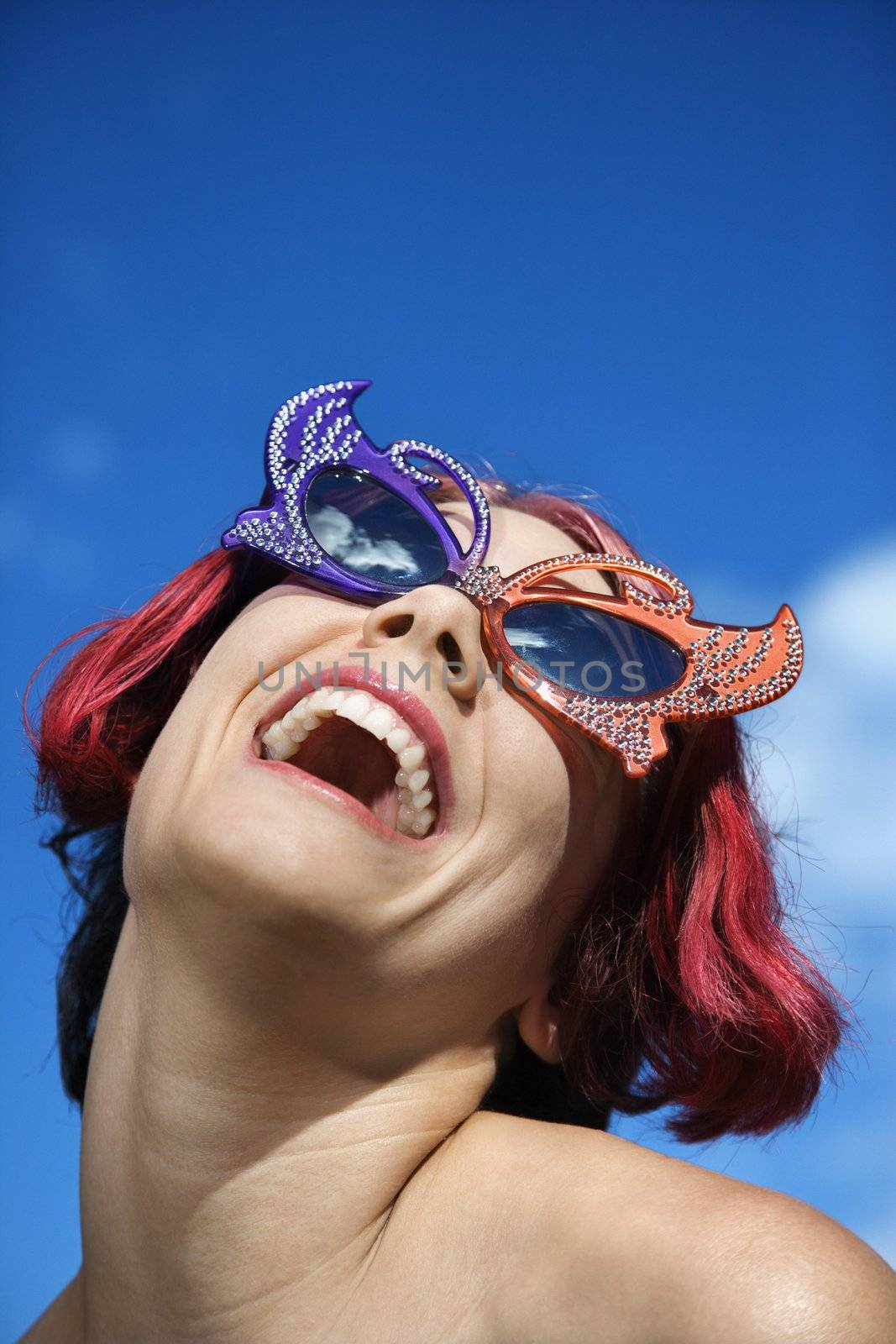 Woman wearing unique sunglasses. by iofoto