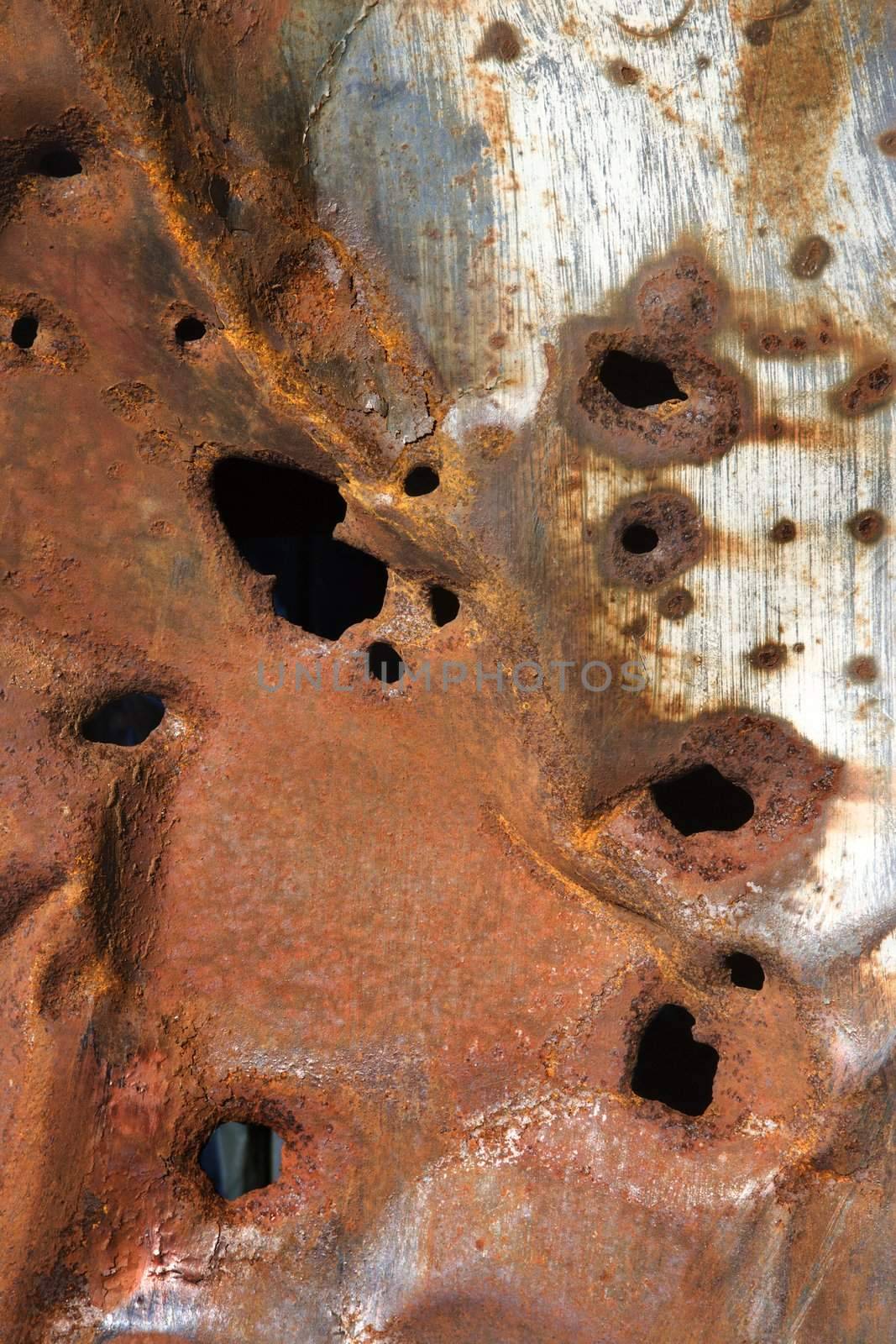 Rusty metal with holes. by iofoto