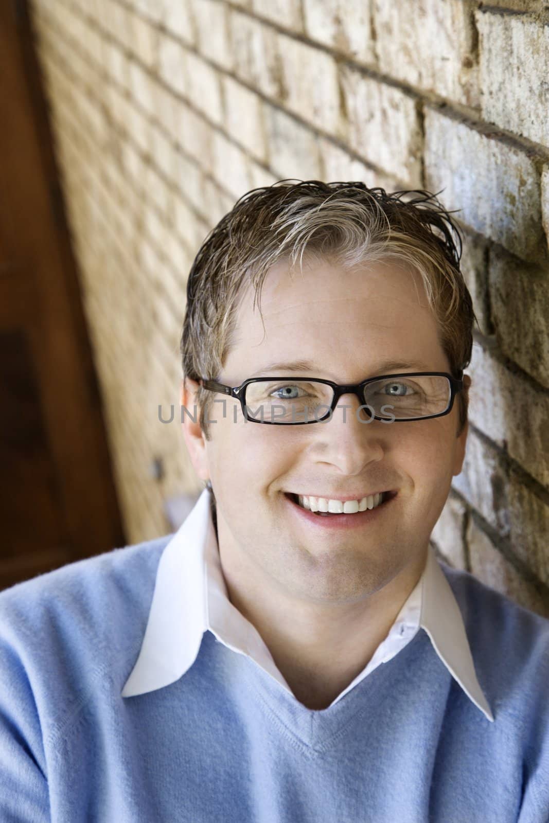 Caucasian adult male wearing glasses and smiling.