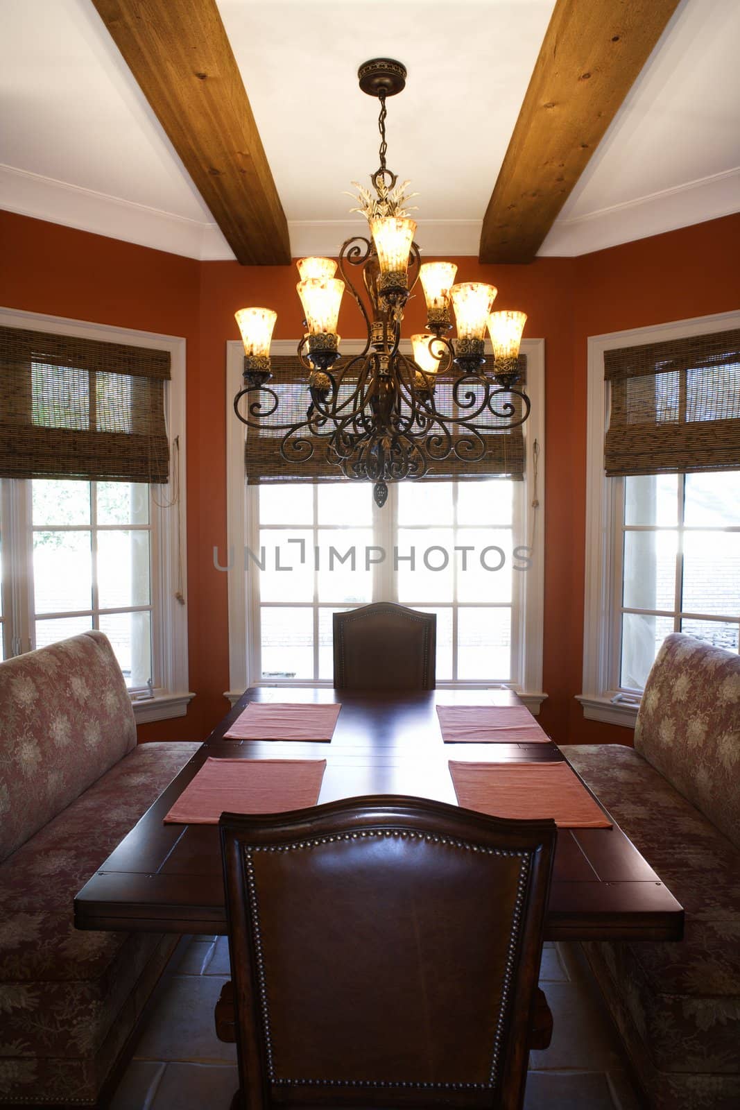 Dining room with table and chairs in affluent home.