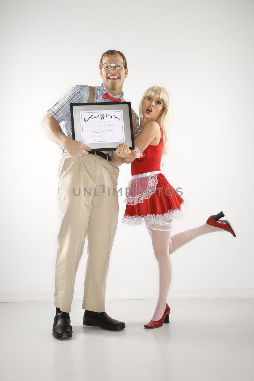 Young Caucasian man holding certificate with young woman.