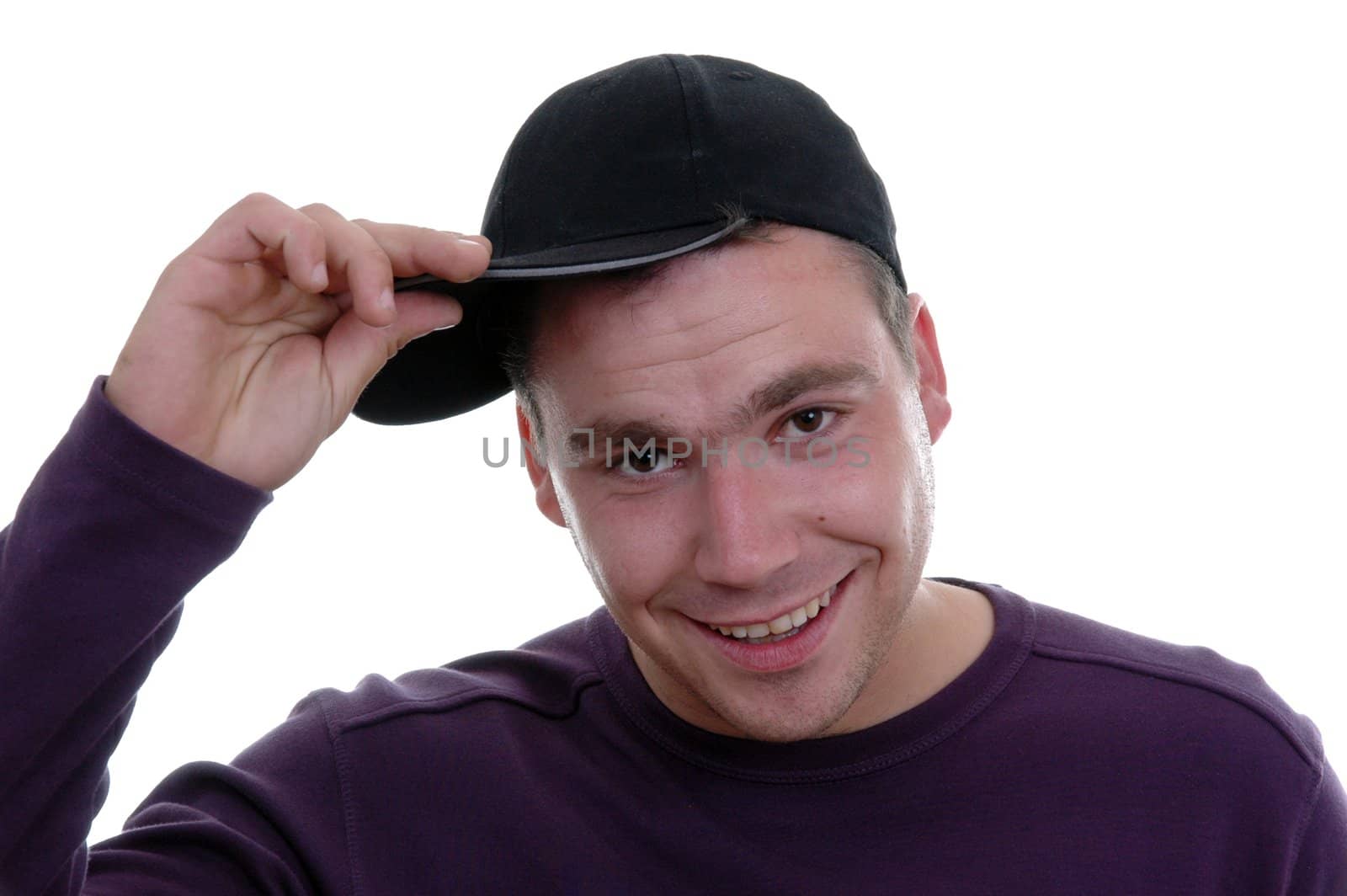 young boy with hand in cap