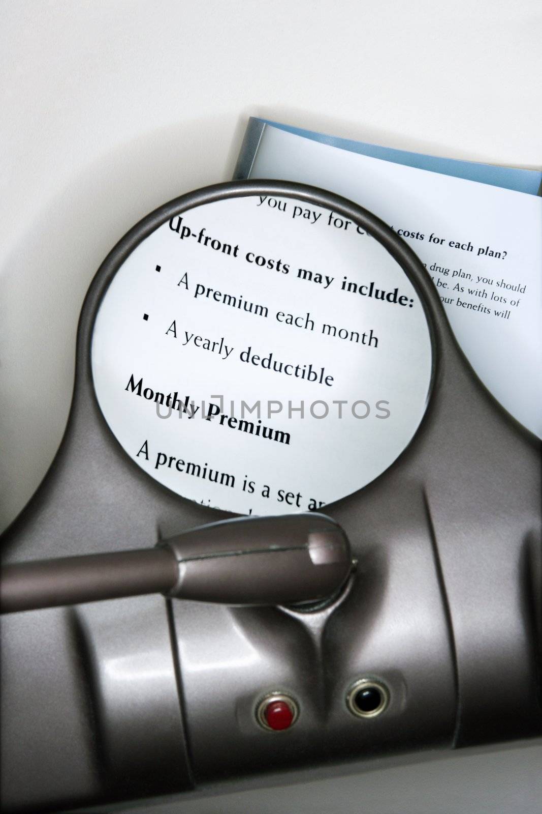 Vision magnifying glass used to view health insurance information.
