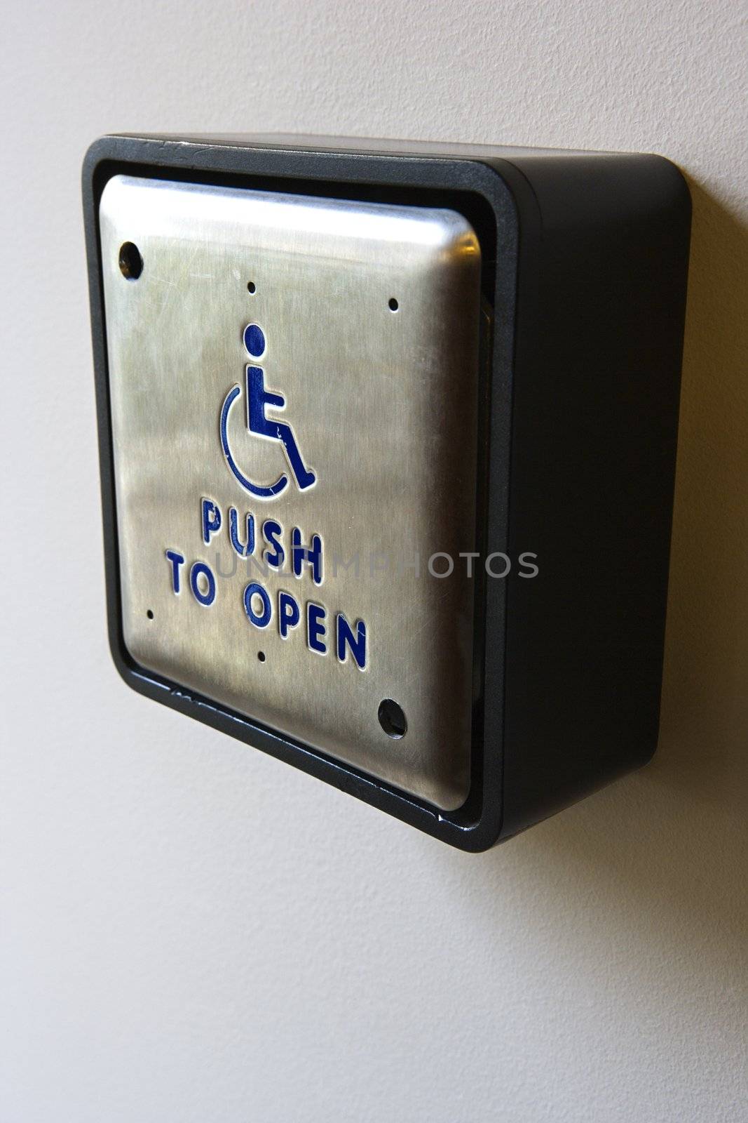 Metal door entrance button for physically challenged or handicapped people.