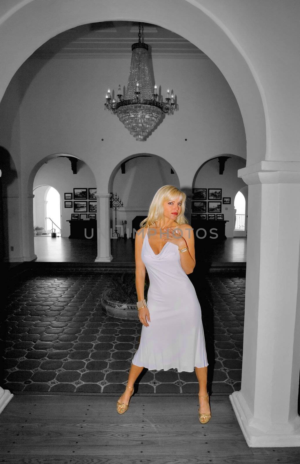 Blond Woman wearin a White Dress in archway B&W and Color.