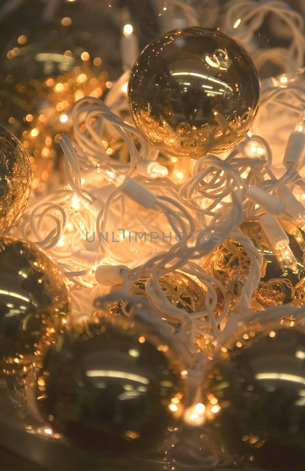 Christmas Balls laying on a string of Lights at the Holiday Season.